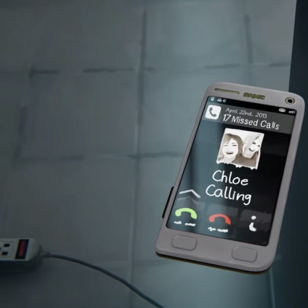 An in-game shot from Life is Strange: Before the Storm. Rachel's cell phone is sitting on a glass table. It reads: "April 22, 2013; 17 Missed Calls; Chloe Calling."